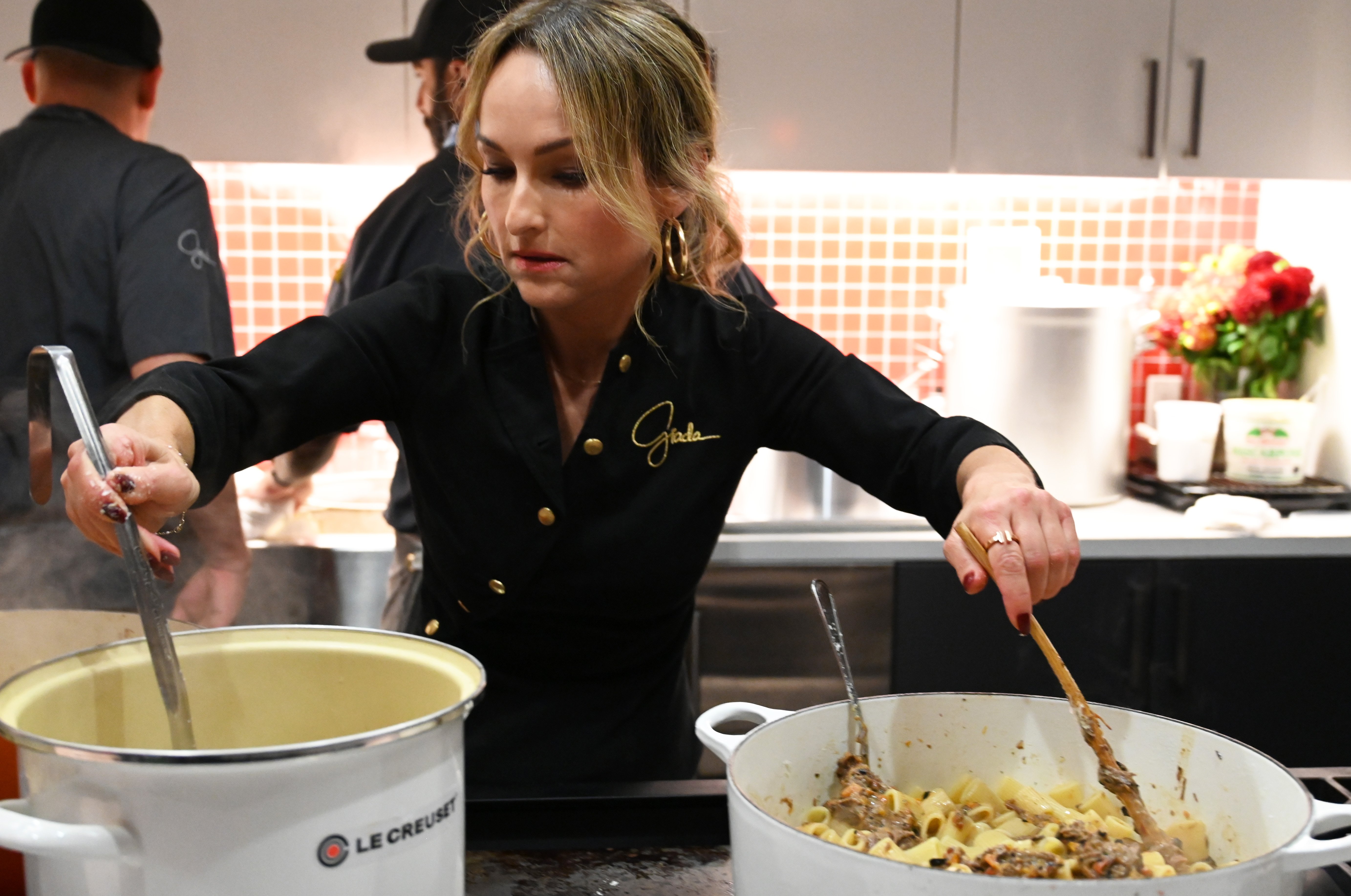 Chef Giada De Laurentiis wears black jacket as she prepares a meal.