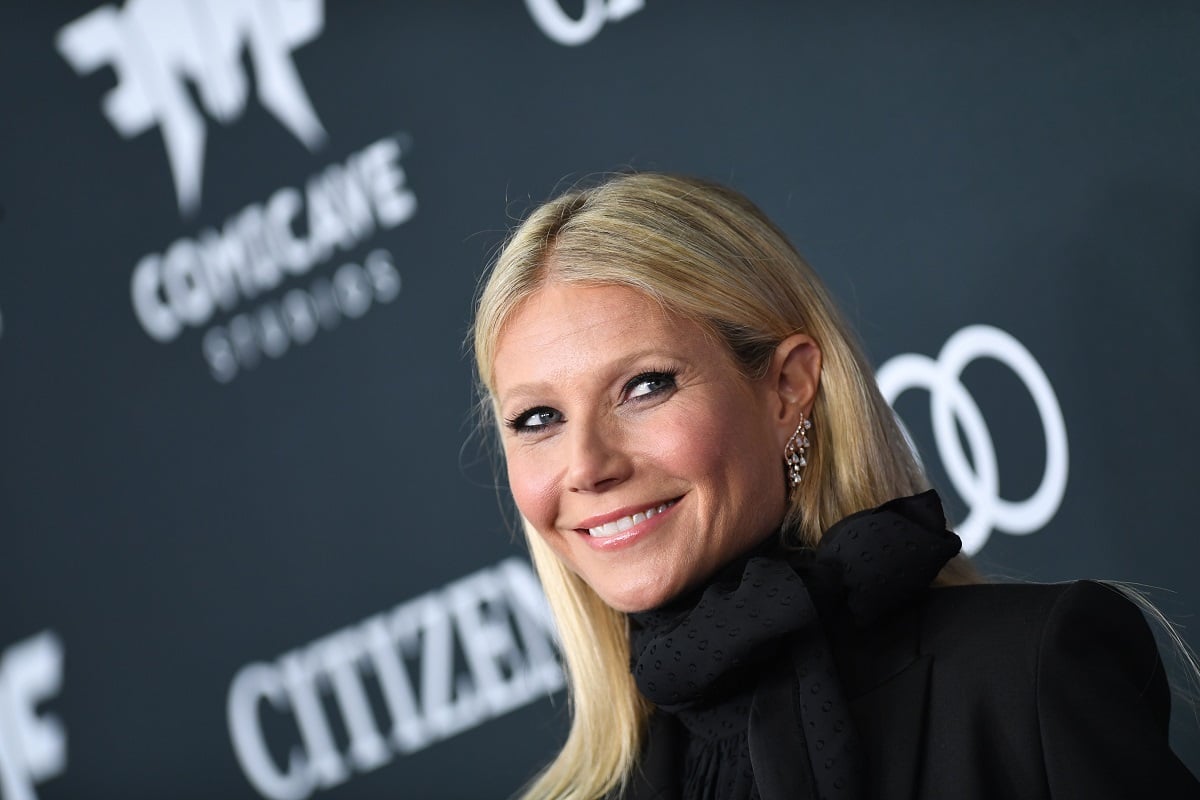 Gwyneth Paltrow smiling while wearing a black jacket.