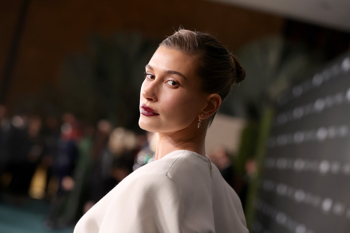 Hailey Bieber poses at an event.
