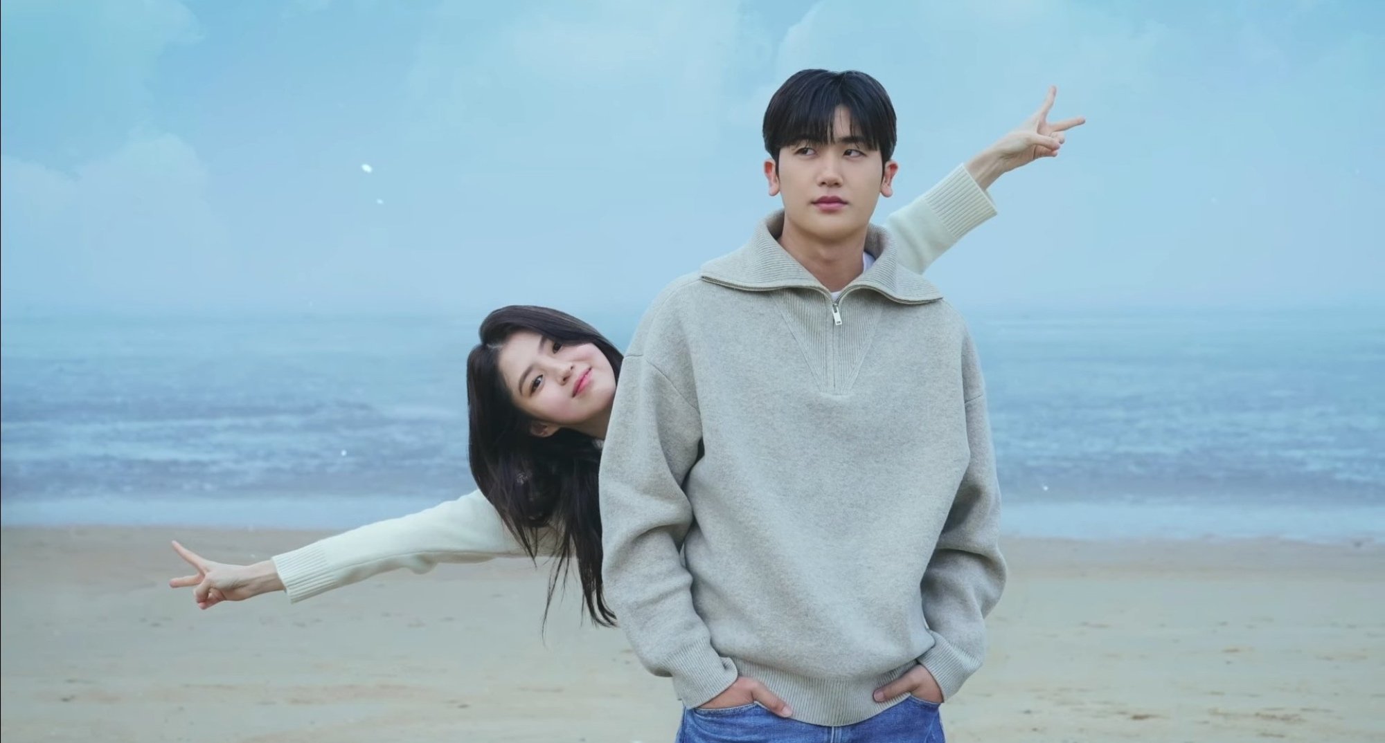 Han So-Hee and Park Hyung-sik for 'Soundtrack #1' on Disney+ on beach and wearing sweaters.