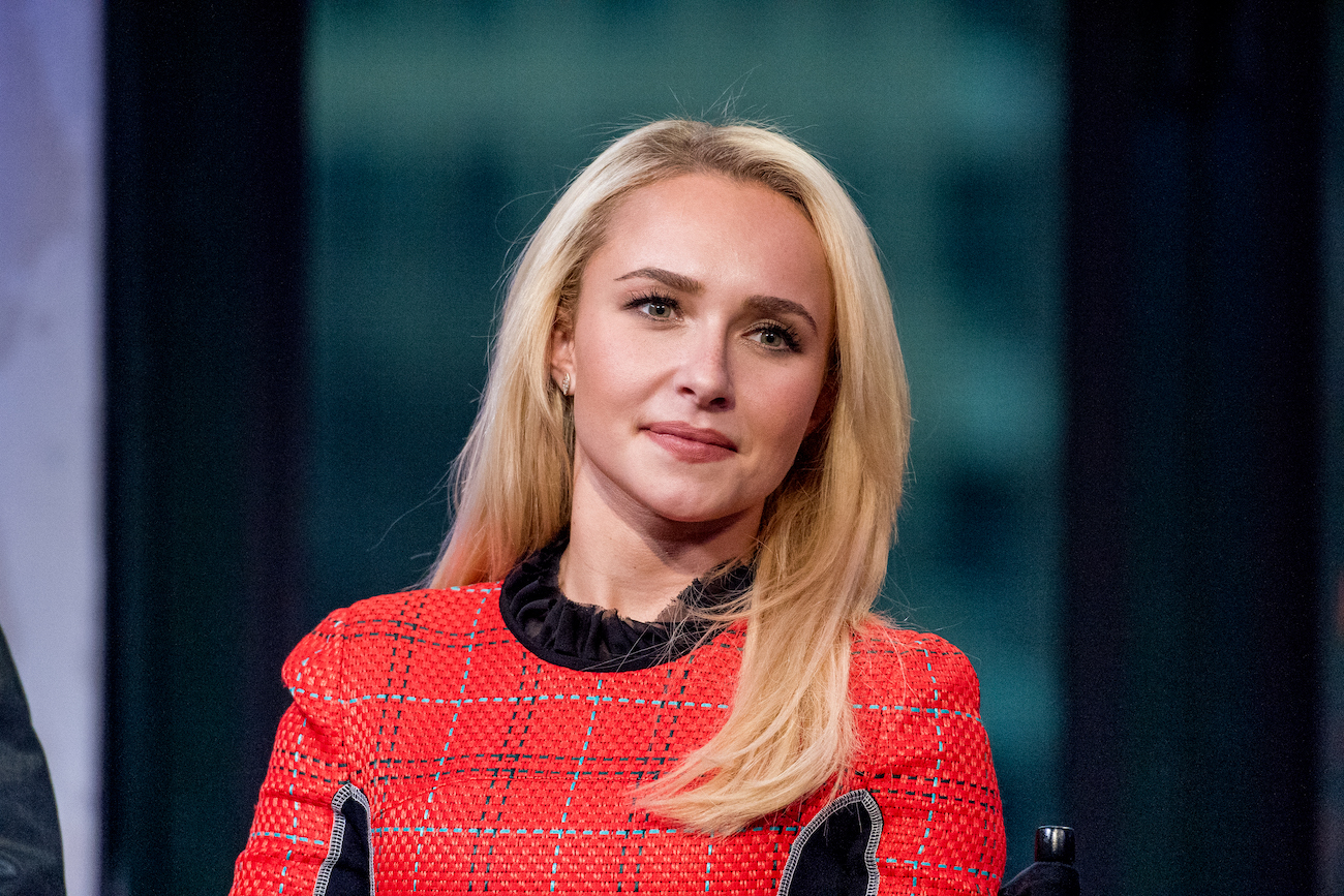 Hayden Panettiere looking on while wearing a red outfit