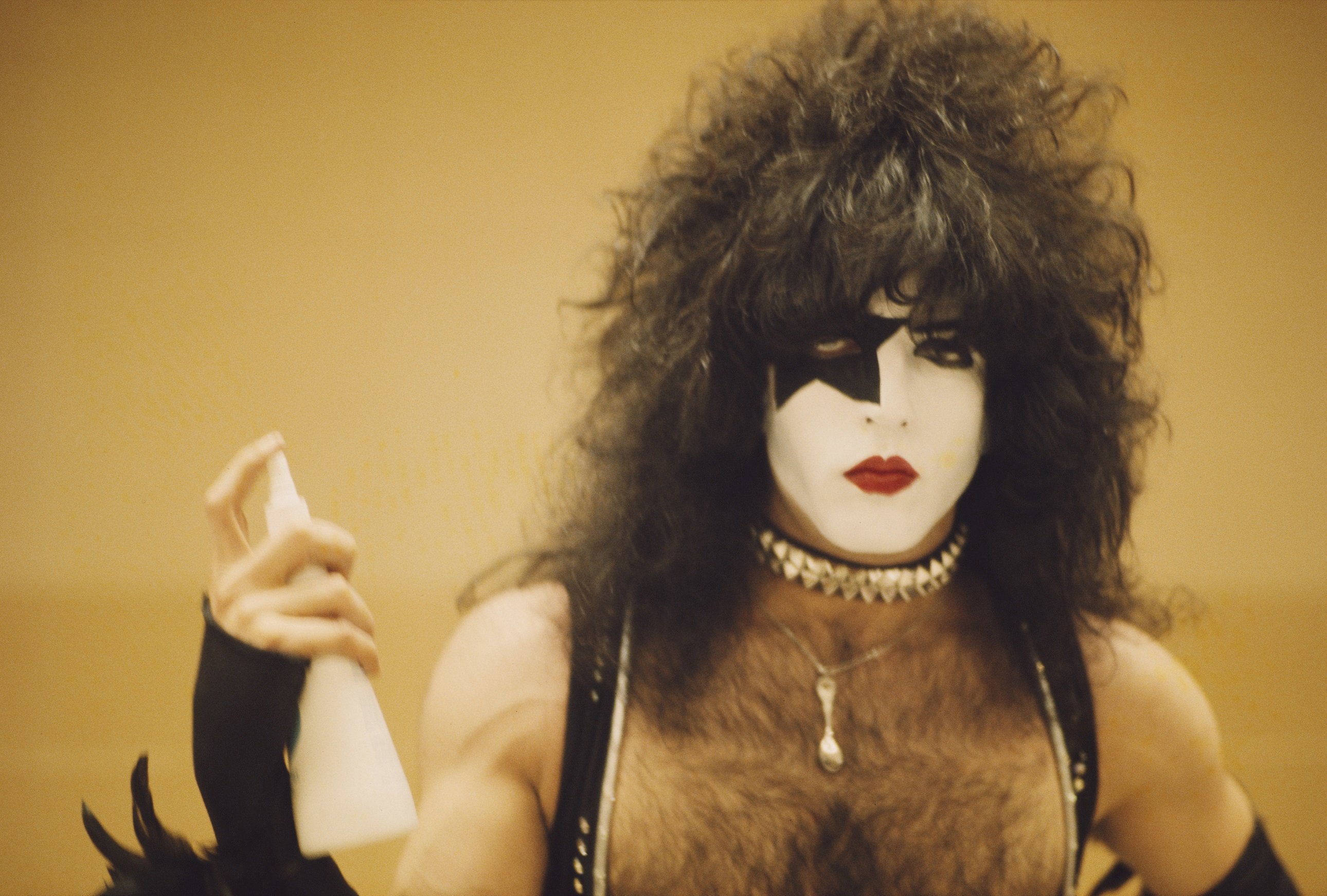 Kiss' Paul Stanley holding a spray bottle