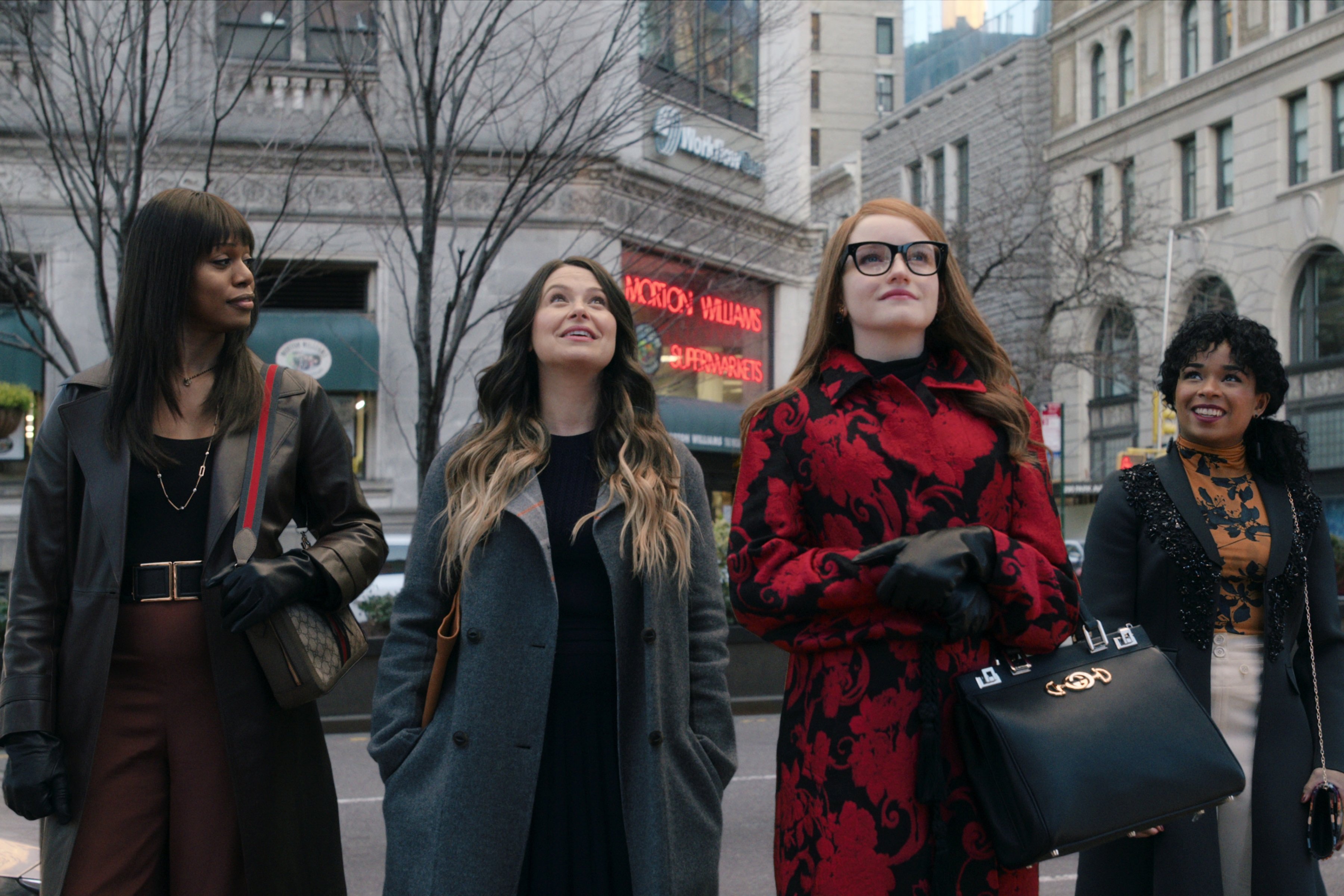 'Inventing Anna' cast members smiling and looking up at the buildings: Laverne Cox, Katie Lowes, Julia Garner and Alexis Floyd