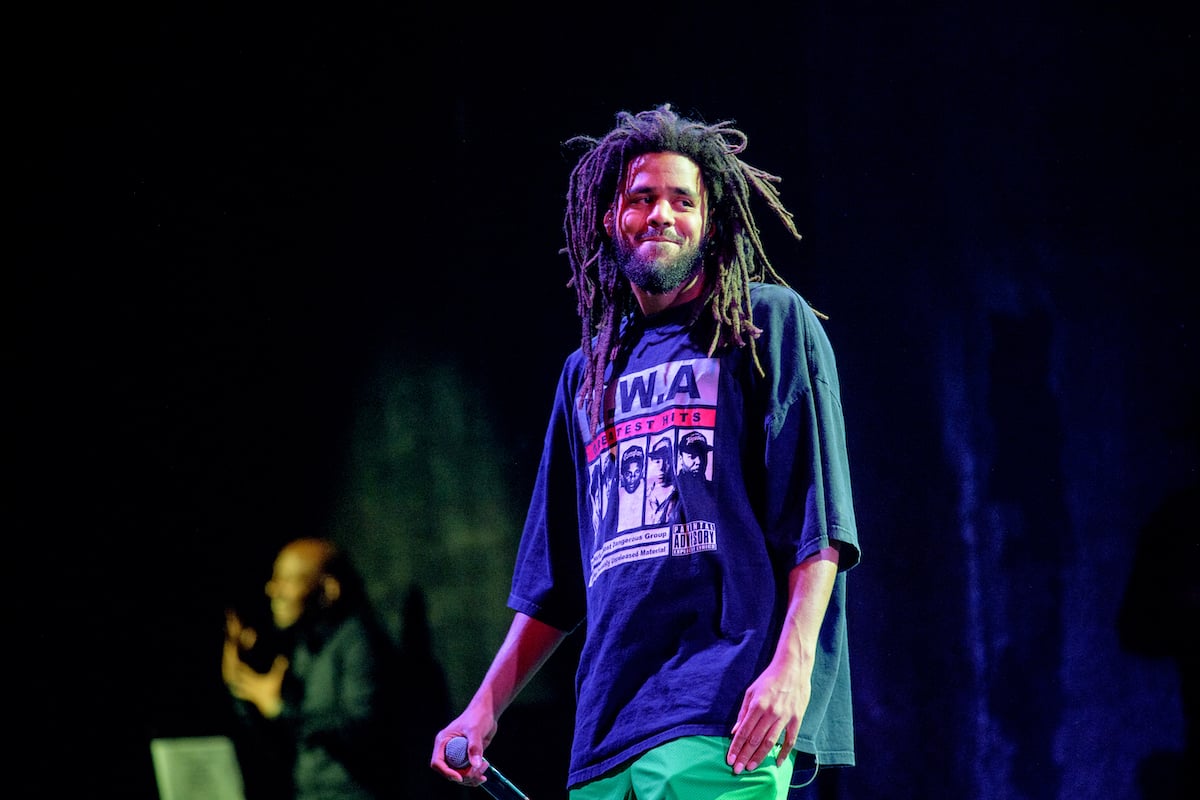 J. Cole smiling on stage