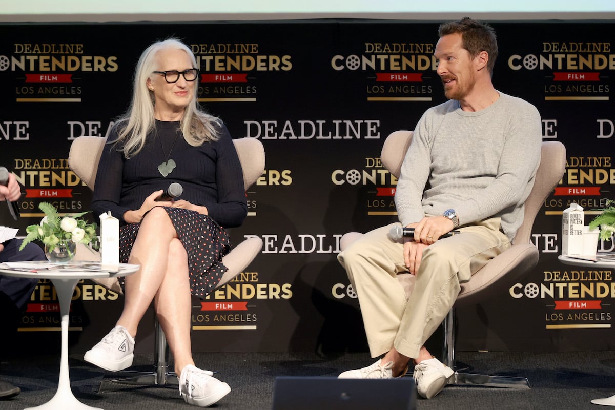 Jane Campion and Benedict Cumberbatch sit onstage holding microphones