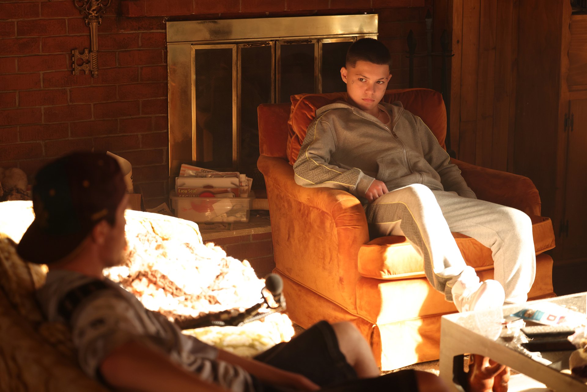 Ashtray (Javon Walton) looks at Custer (Tyler Chase) as he sits on the couch in 'Euphoria' Season 2, Episode 7