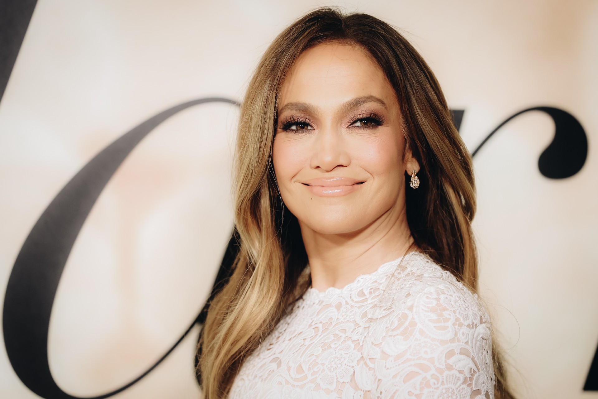 Jennifer Lopez poses in a white wedding dress at the 'Marry Me' premiere.
