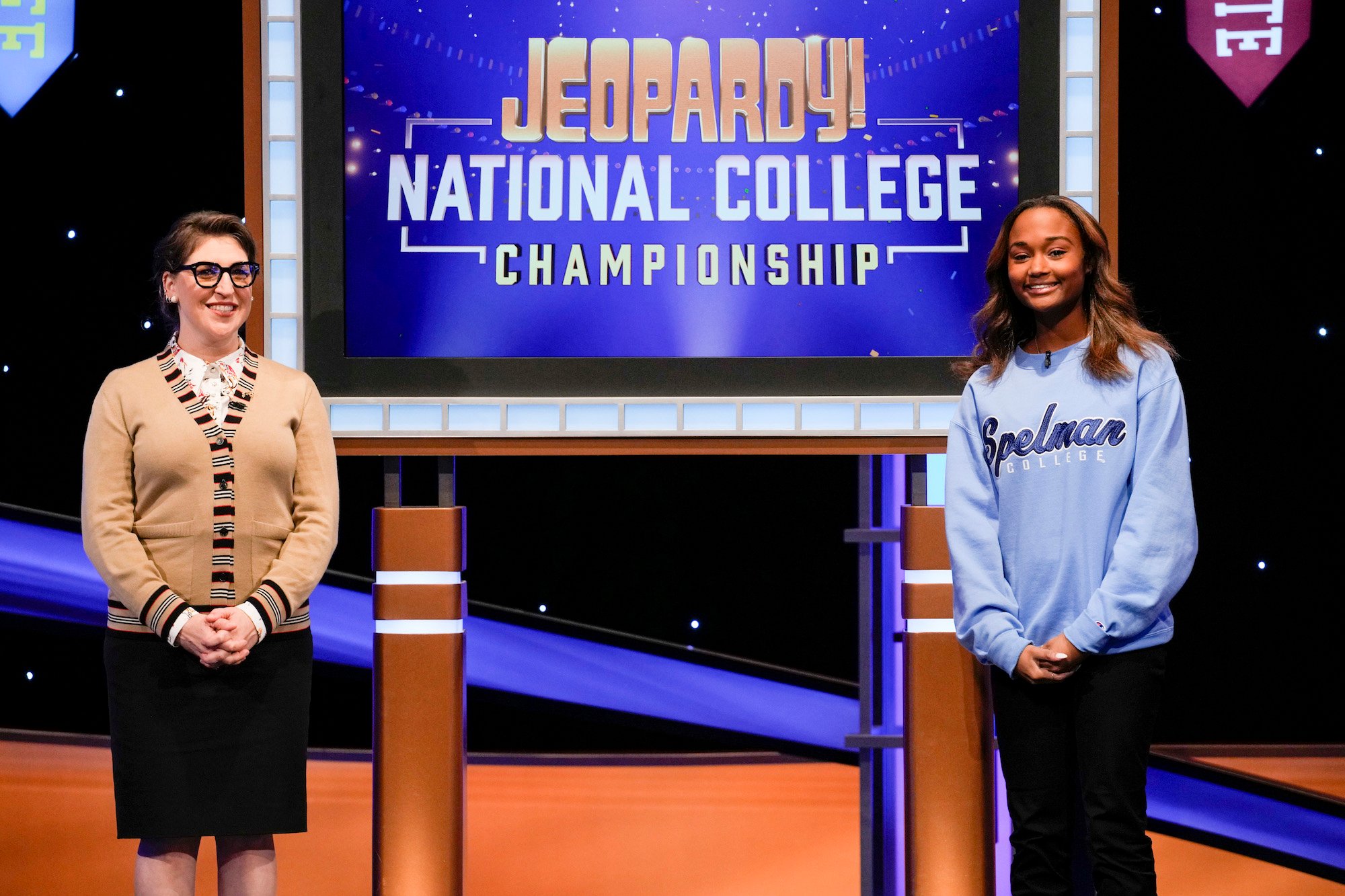 'Jeopardy! National College Championship' host Mayim Bialik stands with a college contestant