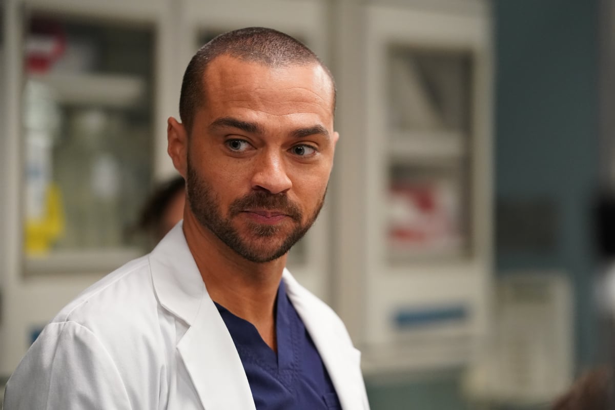 Jesse Williams as Dr. Jackson Avery in a doctor’s coat and dark blue scrubs on Grey’s Anatomy in an image from January 8, 2020