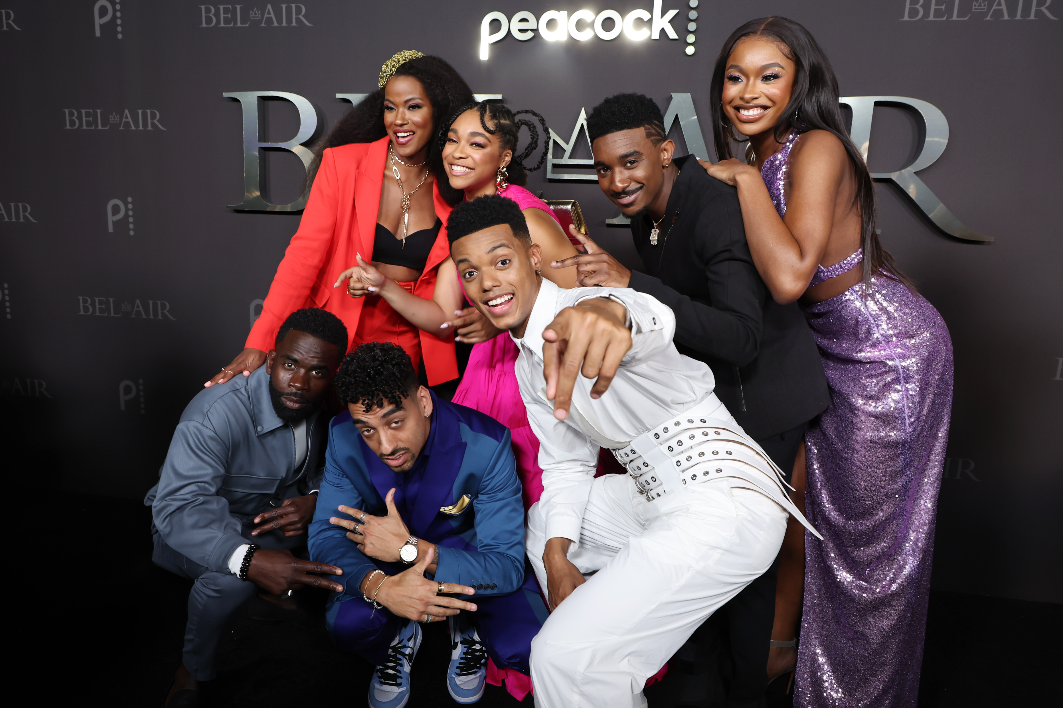 Jimmy Akingbola, Cassandra Freeman, Morgan Cooper, Simone Joy Jones, Jabari Banks, Jordan L. Jones, and Coco Jones posing together and smiling at Peacock's new series 'Bel-Air' premiere party