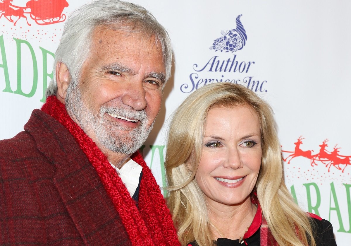 'The Bold and the Beautiful' actor John McCook wearing a red coat and scarf; poses with co-star Katherine Kelly Lang