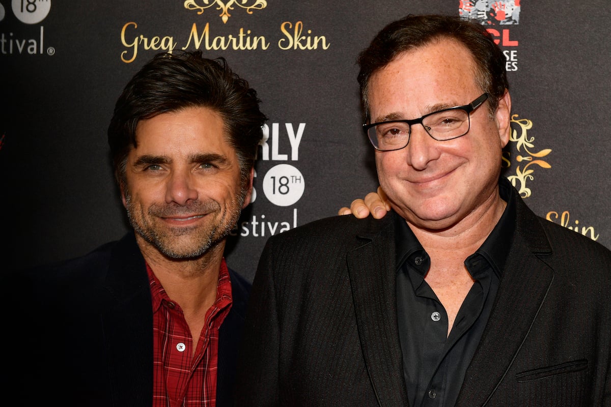 John Stamos and Bob Saget pose together at an event.