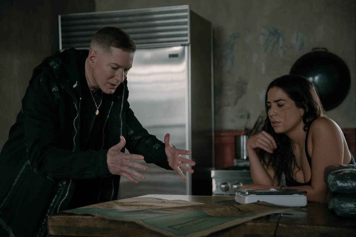 Joseph Sikora as Tommy Egan and Audrey Esparza as Liliana discussing plans over the kitchen counter in 'Power Book IV: Force'