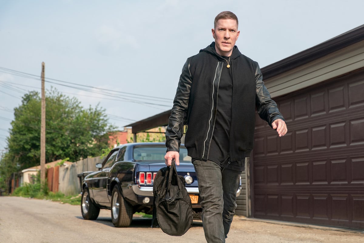 Joseph Sikora as Tommy Egan holding a bag and walking away from his Mustangon 'Power Book IV: Force'
