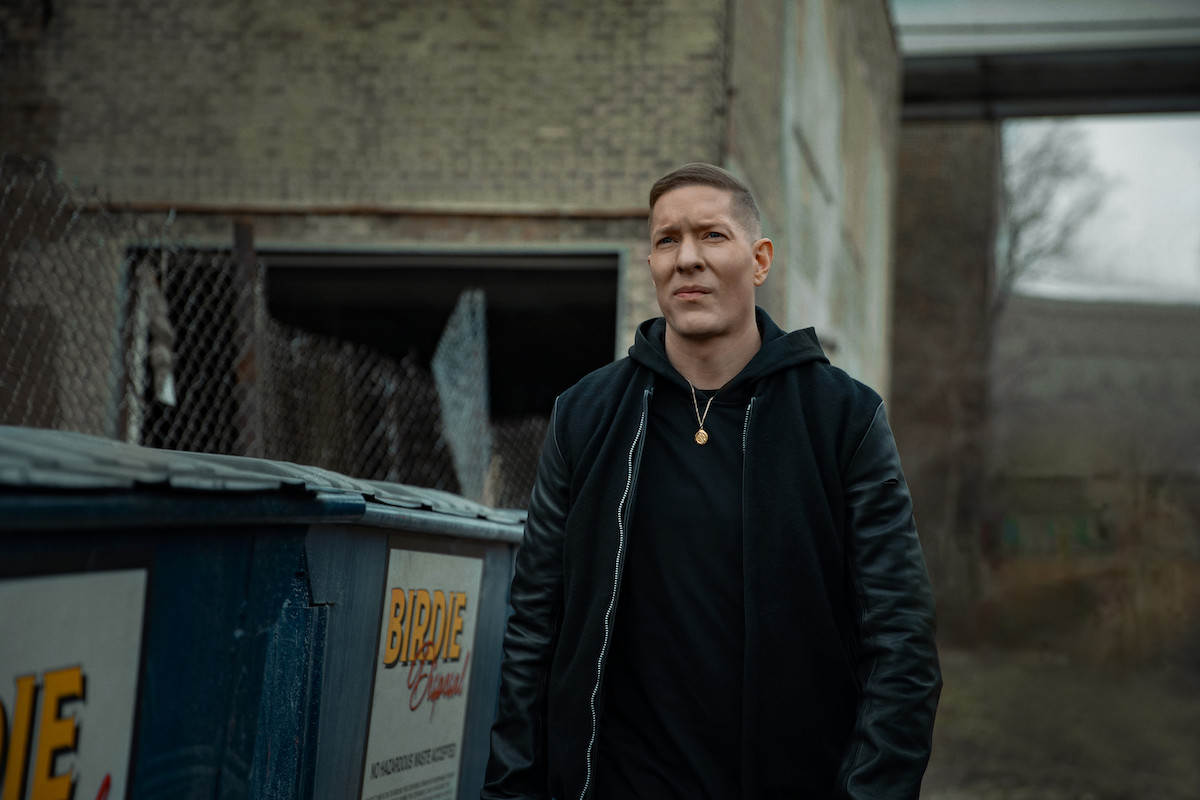 Jospeh Sikora as Tommy Egan standing next to some dumpsters wearing all black in 'Power Book IV: Force'