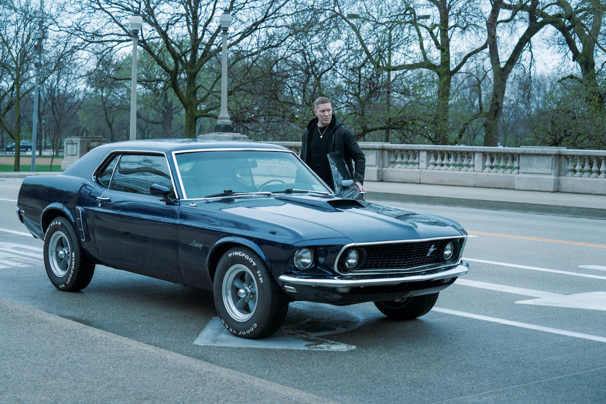 Joseph Sikora as Tommy Egan getting out of a blue mustang in 'Power Book IV: Force'