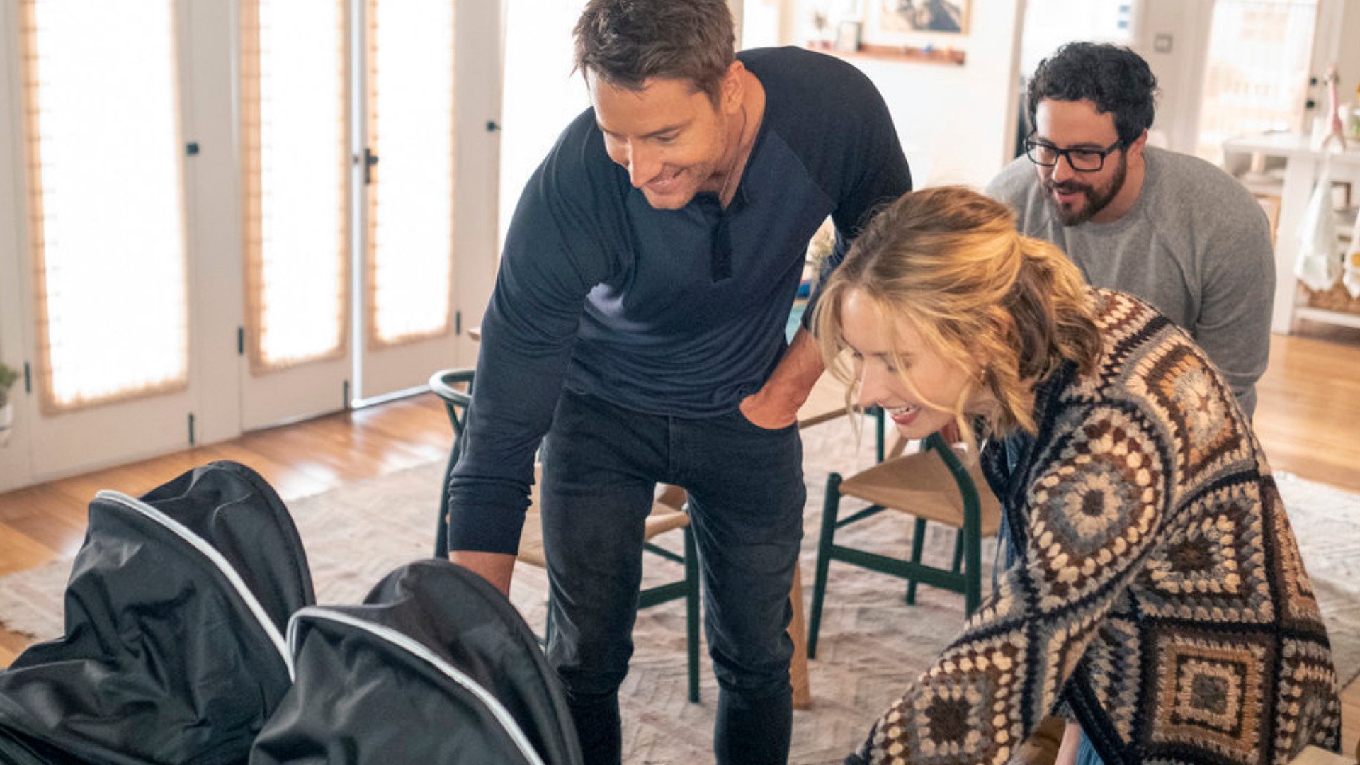 Justin Hartley as Kevin, Adam Korson as Elijah, and Caitlin Thompson as Madison looking at twins Franny and Nicky in ‘This Is Us’ Season 6 Episode 5