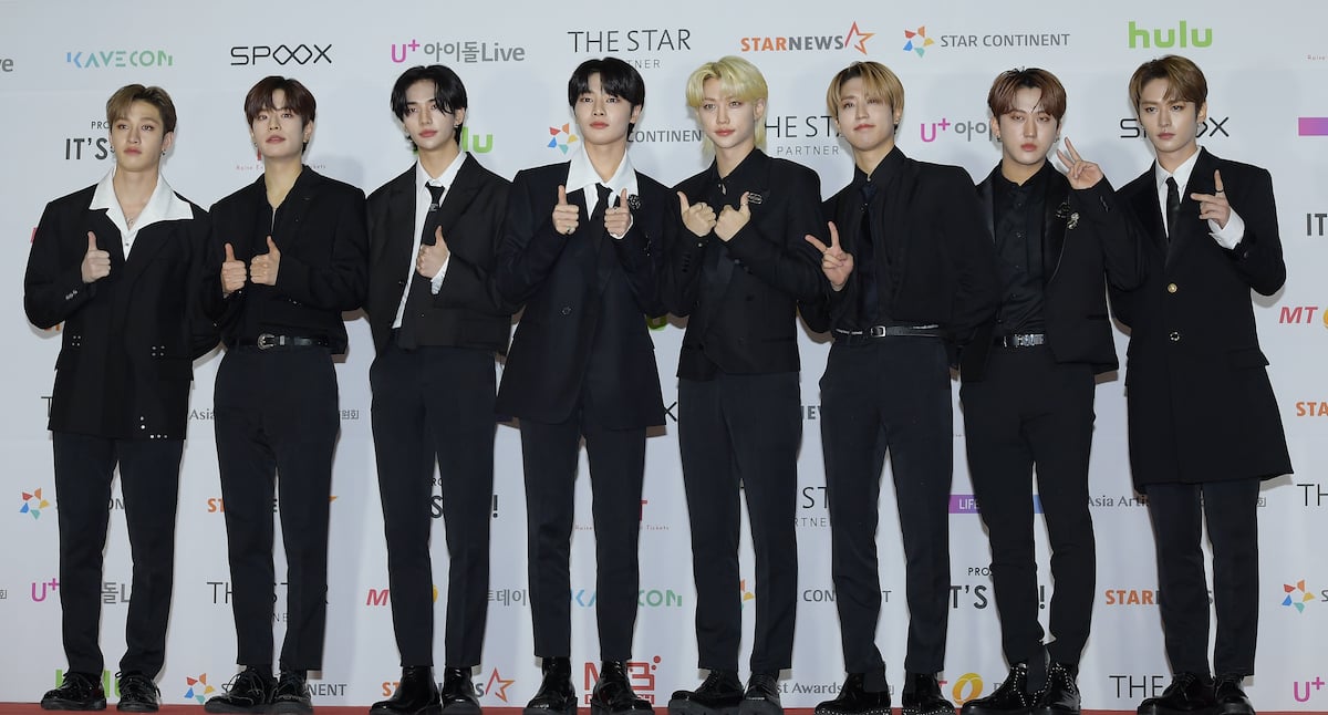 The members of Stray Kids hold up peace signs at the Asia Artist Awards 2021