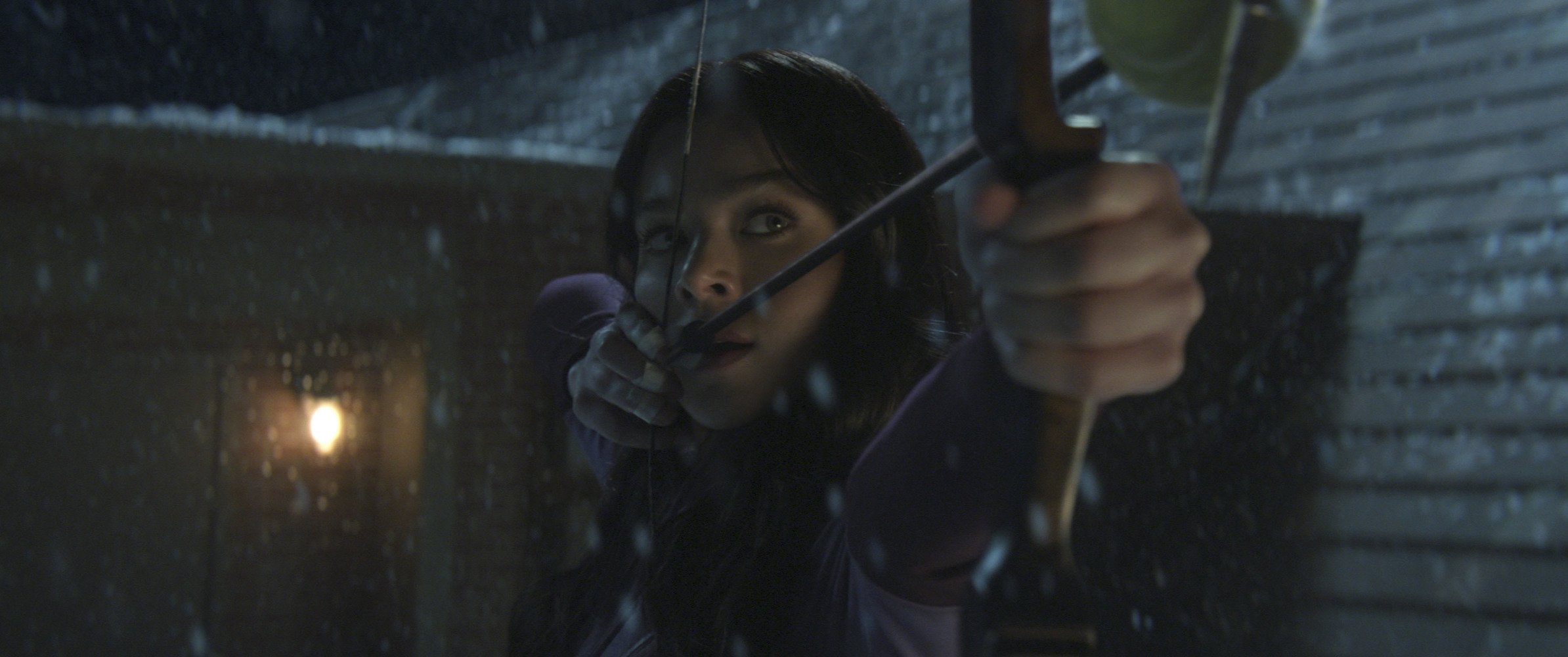 Hailee Steinfeld as Kate Bishop in Marvel's 'Hawkeye.' She's shooting a bow and arrow.