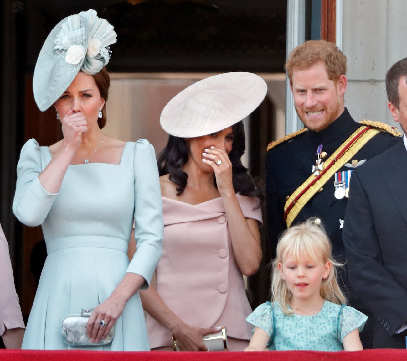 Kate Middleton and Meghan Markle covering their mouths at Trooping the Colour 2018