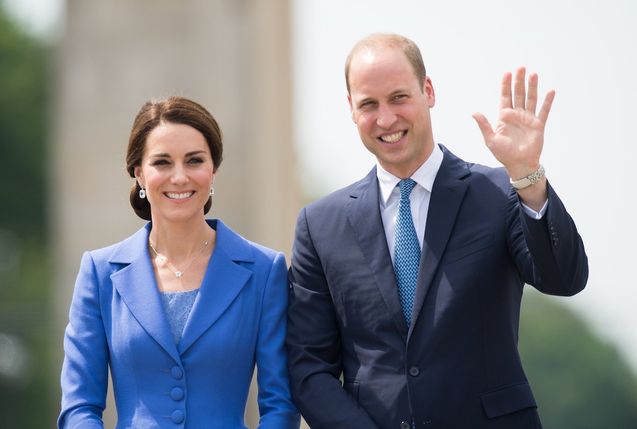 Kate Middleton smiling while wearing a blue outfit, Prince William smiling and waving while wearing a suit