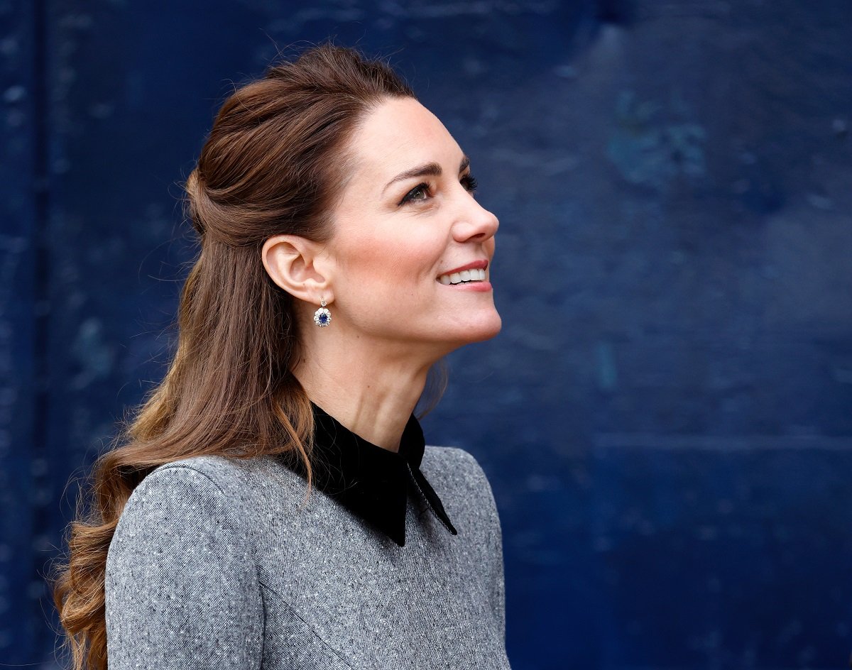 Kate Middleton looking up and smiling during a visit to The Prince's Foundation training site