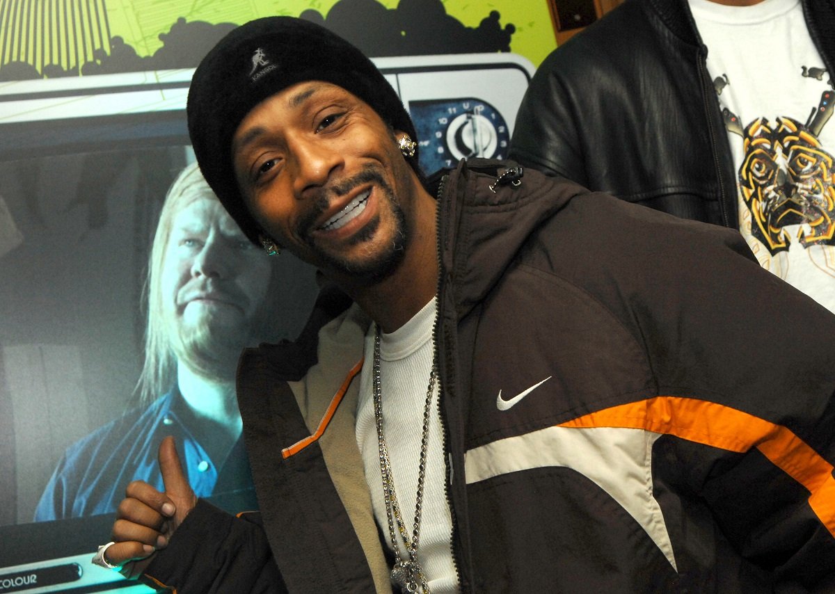 Katt Williams smiling while wearing a hat.