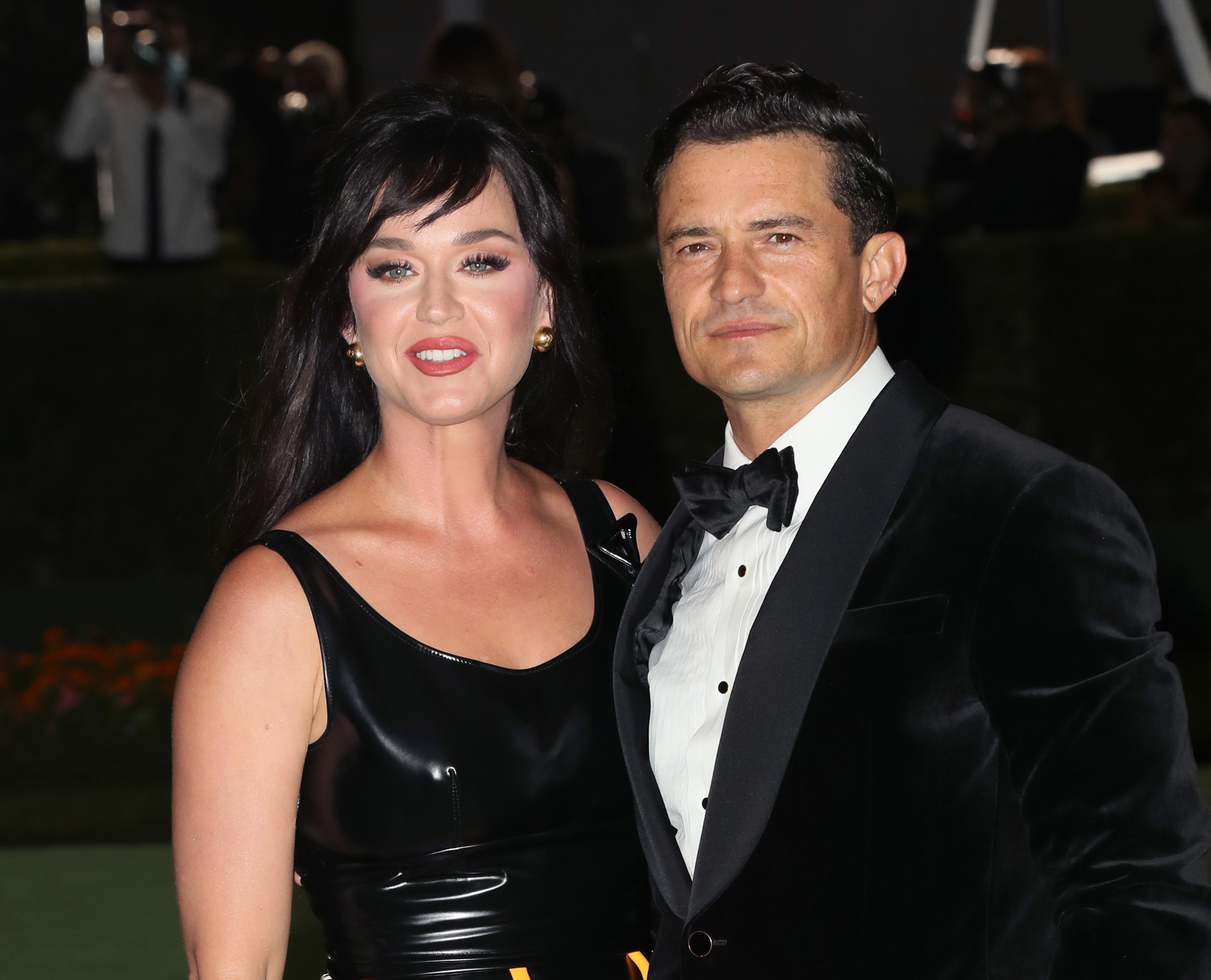 Katy Perry and Orlando Bloom pose for a photo together outside The Academy Museum of Motion Pictures Opening Gala