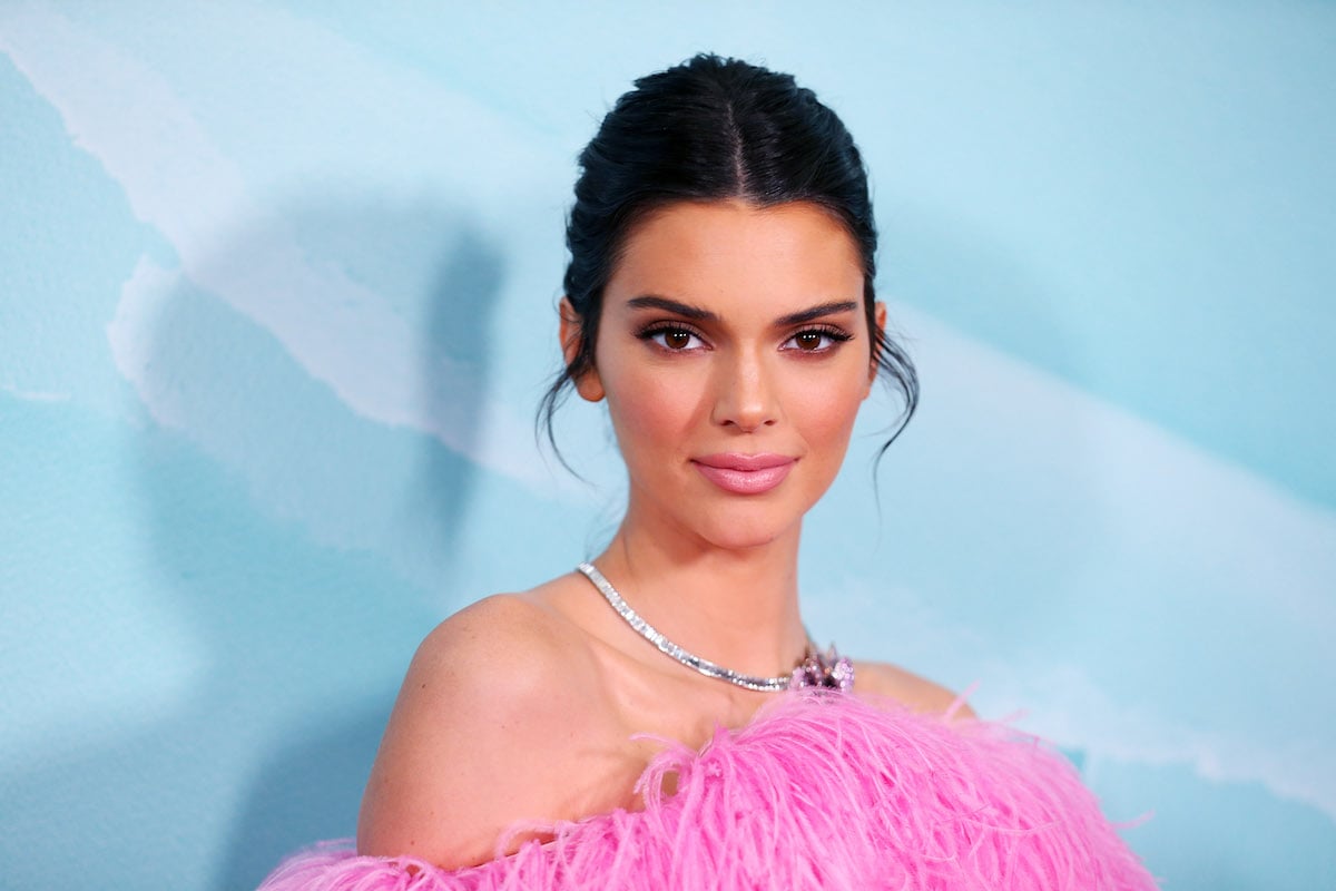 Kendall Jenner wears pink to an event.
