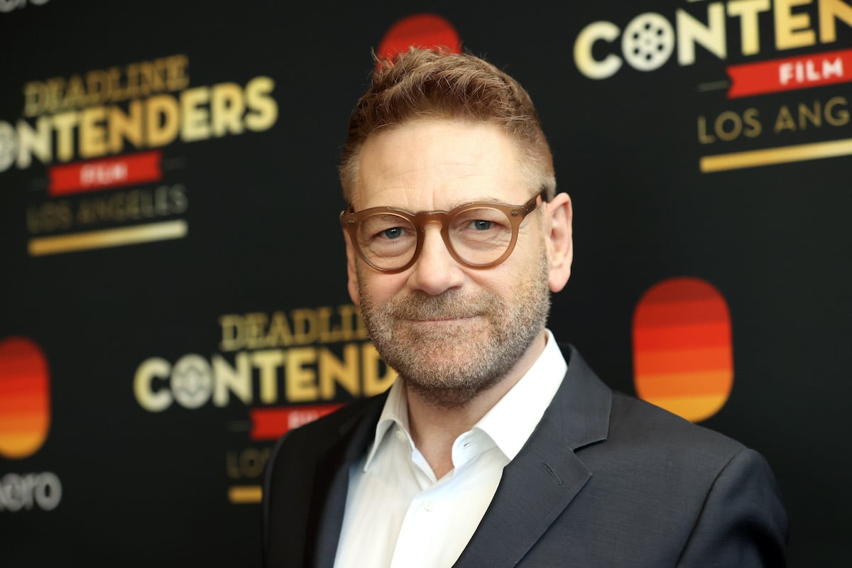 Kenneth Branagh poses in a suit and glasses