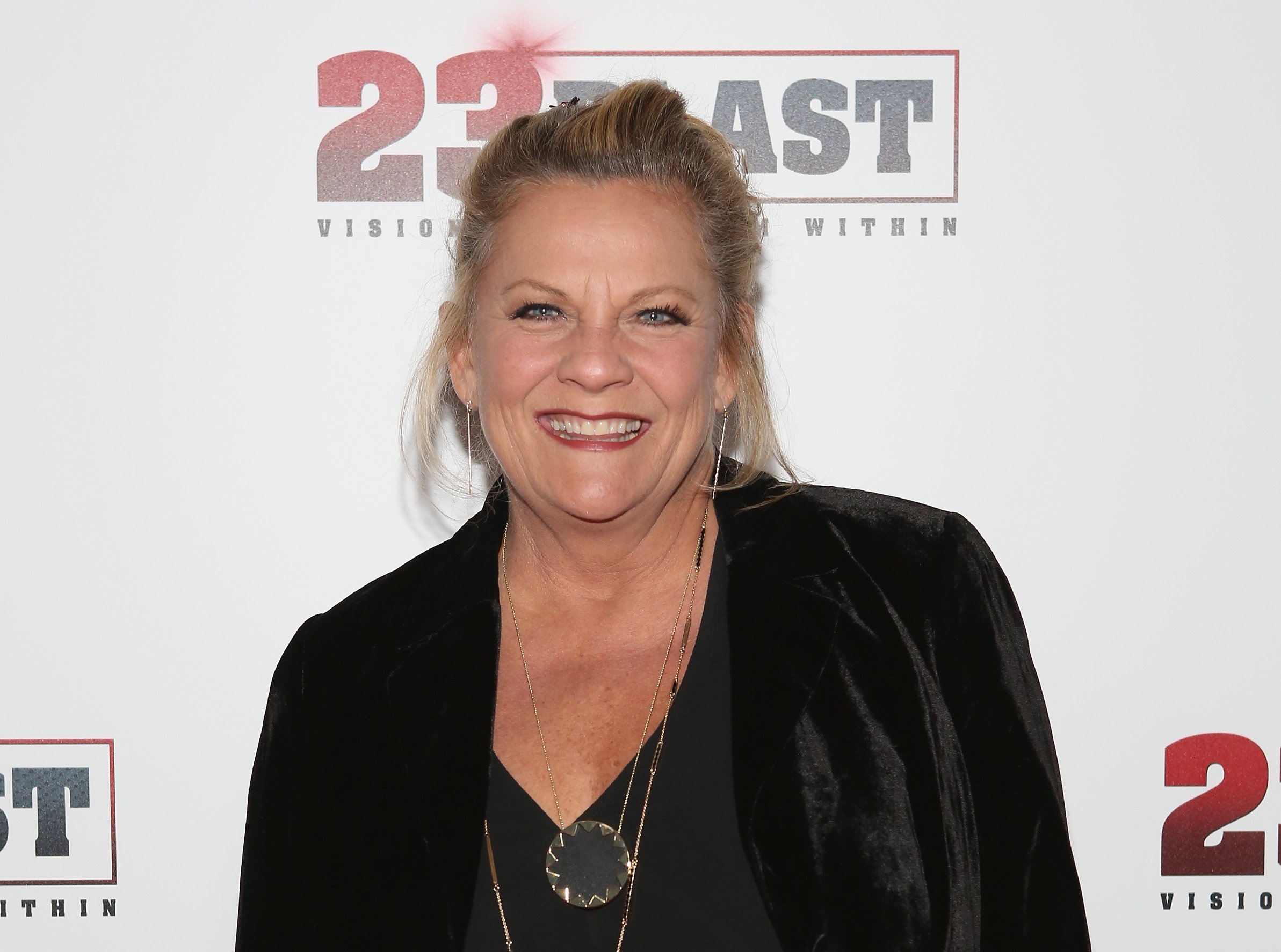 'Guiding Light' actor Kim Zimmer wearing a black blouse and leather jacket during a red carpet appearance.