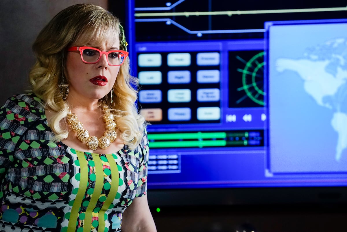 Kirsten Vangsness, wearing pink glasses and patterned top, in 'Criminal Minds'
