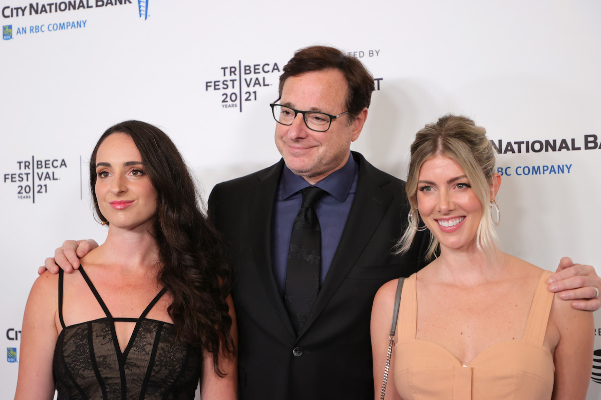 Lara Saget, Bob Saget, and Kelly Rizzo pose together at an event.