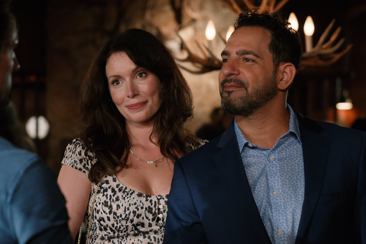 Lauren Hammersley as Charmaine and Patrick Sabongui as Todd arm in arm at a bar in 'Virgin River'