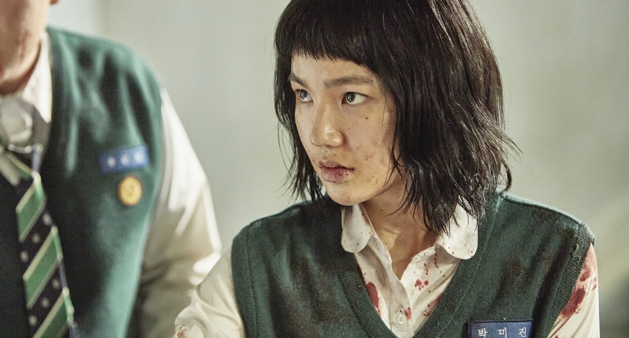 Lee Eun-saem as Mi-jin in 'All of Us Are Dead' wearing school uniform and covered in blood.