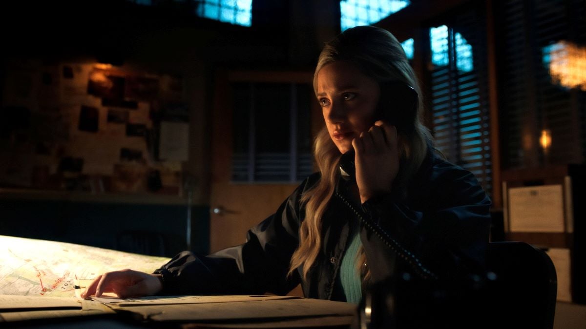 Lili Reinhart as Betty cooper in 'Riverdale' Season 5 sitting at a desk on the phone