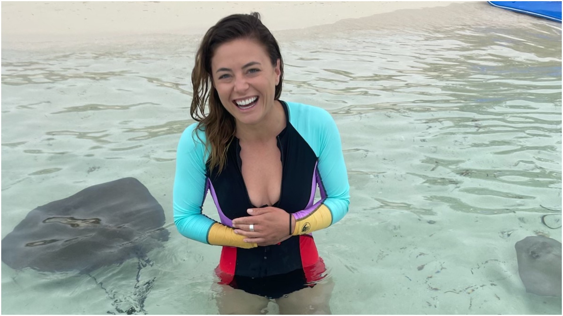Malia White from 'Below Deck Med' smiles while being surrounded by stingrays 
