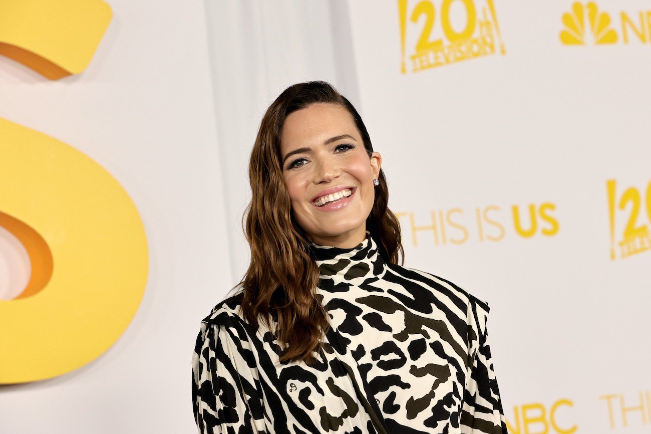 Mandy Moore poses for cameras wearing a black and white printed dress