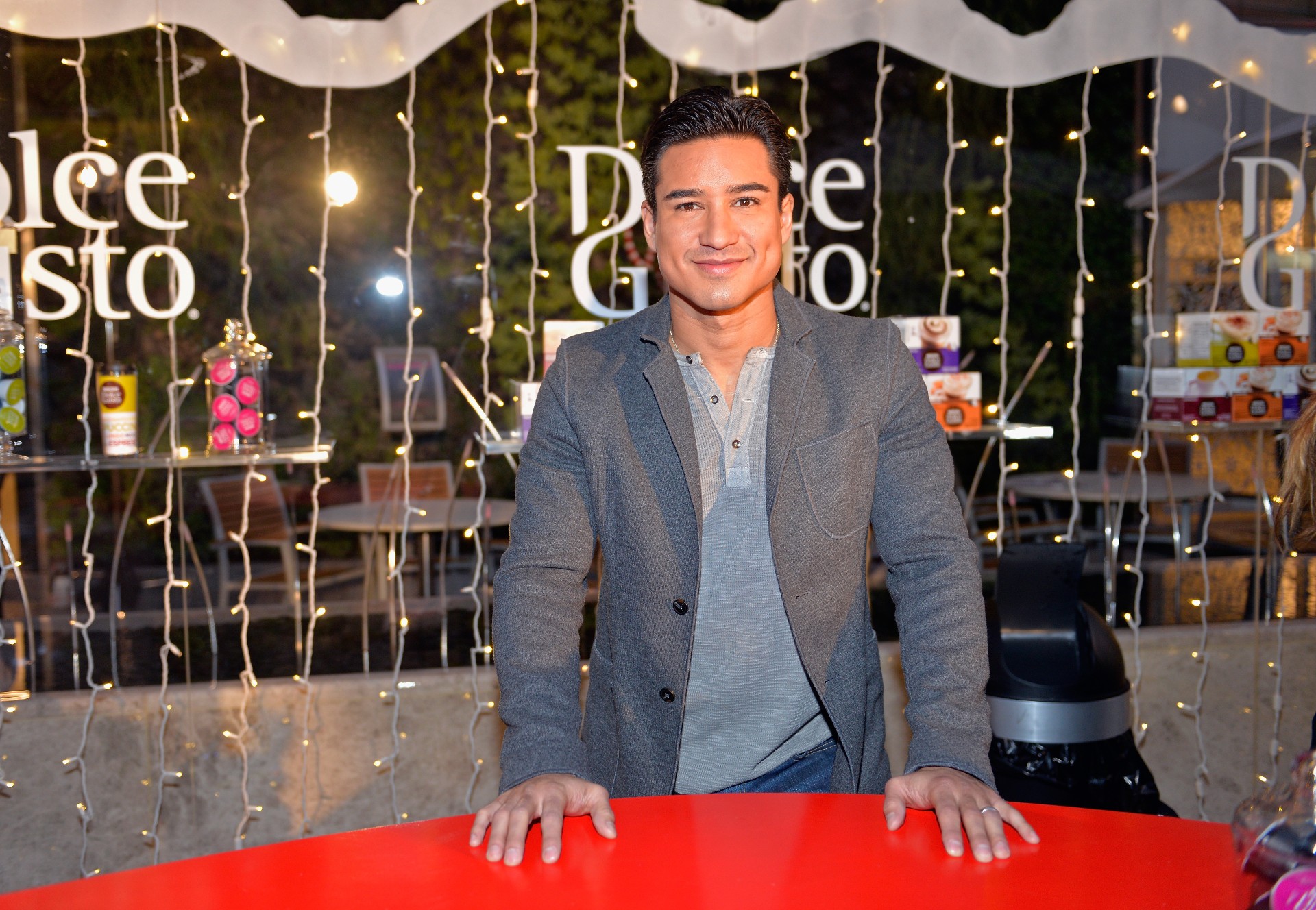Mario Lopez smiles while at an event.