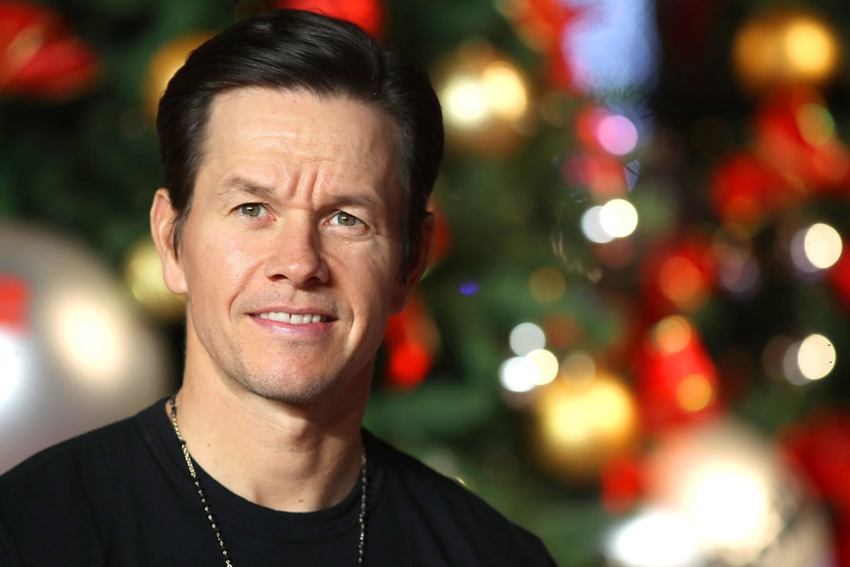 Mark Wahlberg smiling while wearing a black shirt.