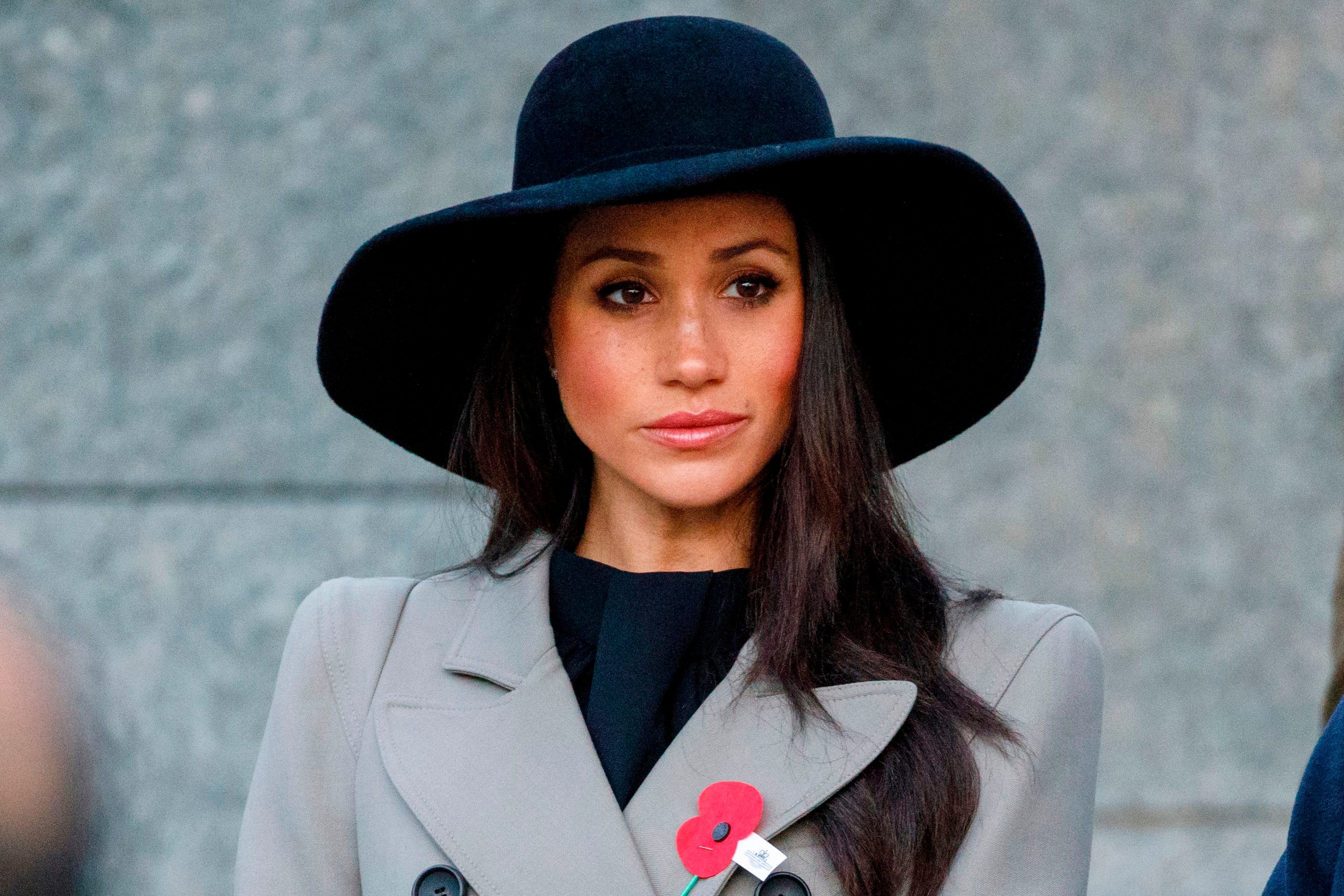 Meghan Markle wearing a black hat and gray coat to an Anzac Day service