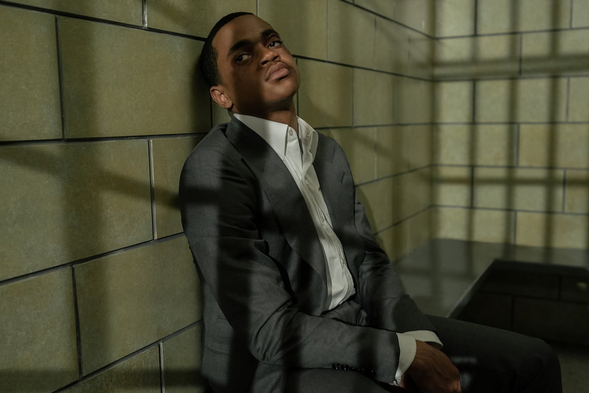 Michael Rainey Jr. as Tariq St. Patrick sitting in a jail cell wearing a suit in 'Power Book II: Ghost' 