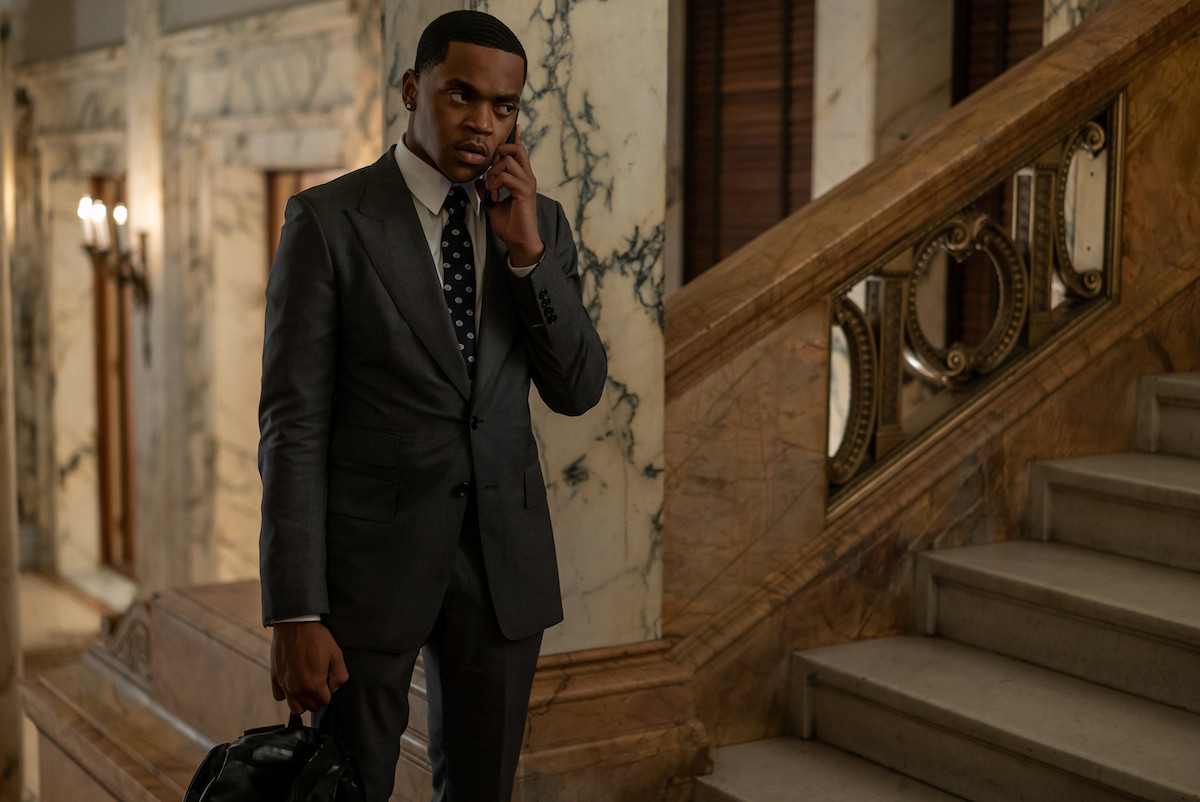 Michael Rainey Jr. as Tariq St. Patrick wearing a dark suit while talking on the phone in 'Power Book II: Ghost'