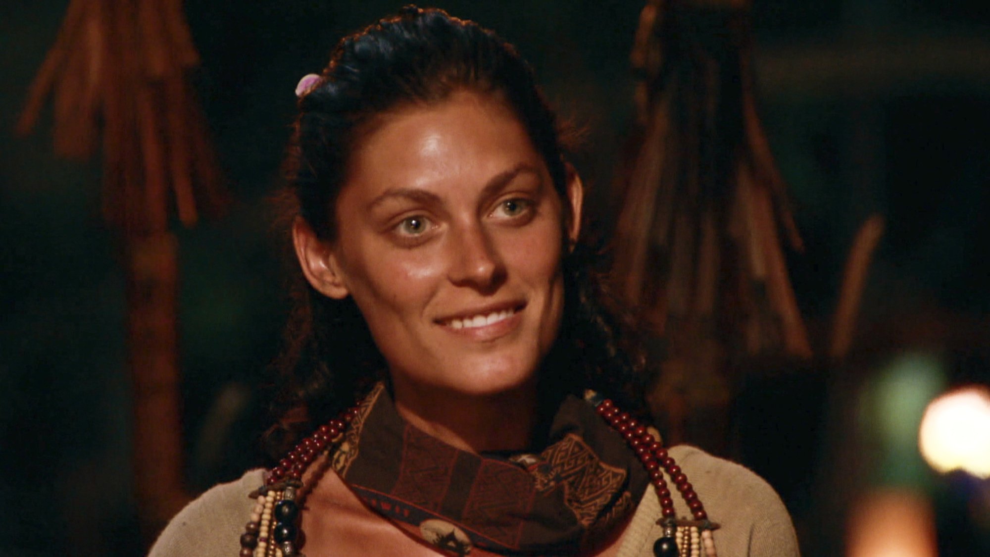 A close-up of Michele Fitzgerald, a contestant on 'The Challenge' Season 37, at Tribal Council in 'Survivor'