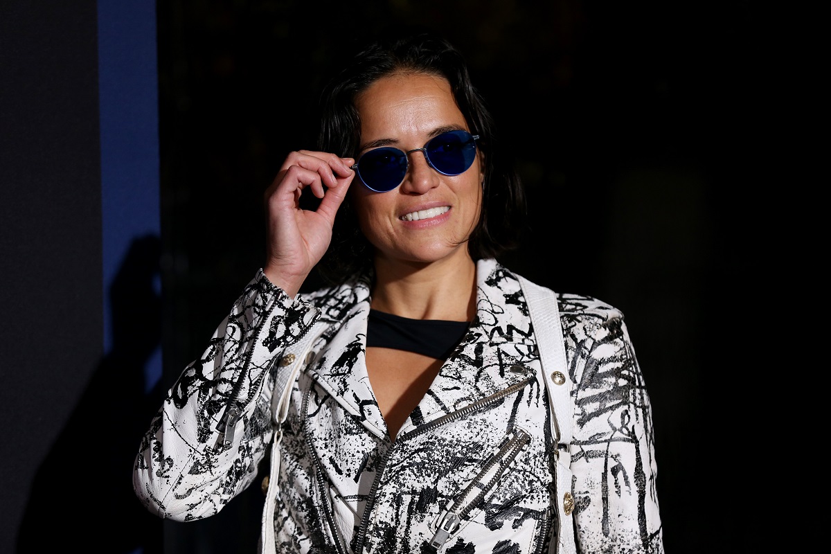 Michelle Rodriguez smiling while wearing sunglasses.