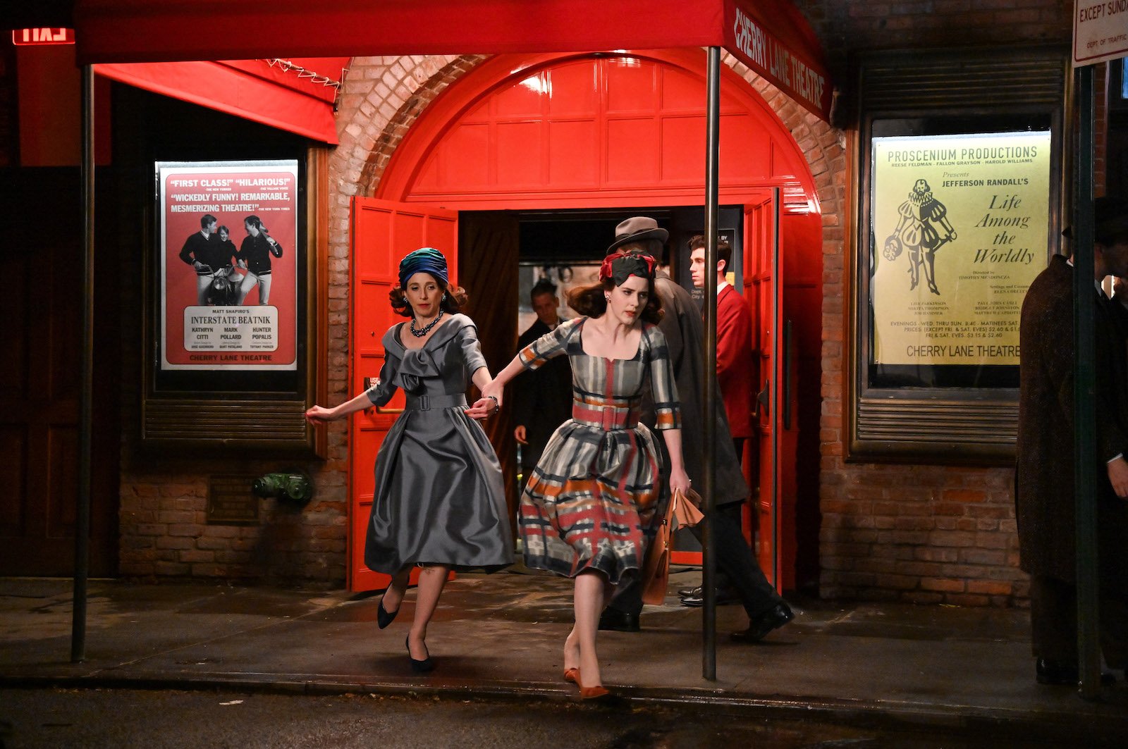 Marin Hinkle and Rachel Brosnahan run from a nightclub hand in hand on 'The Marvelous Mrs. Maisel'