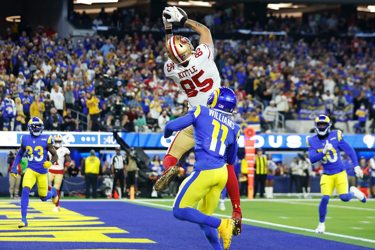 NFL players George Kittle #85 of the San Francisco 49ers catches a 16 yard touchdown in the third quarter against Darious Williams #11 of the Los Angeles Rams in the NFC
