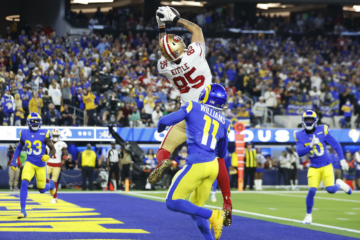 NFL players George Kittle #85 of the San Francisco 49ers catches a 16 yard touchdown in the third quarter against Darious Williams #11 of the Los Angeles Rams in the NFC