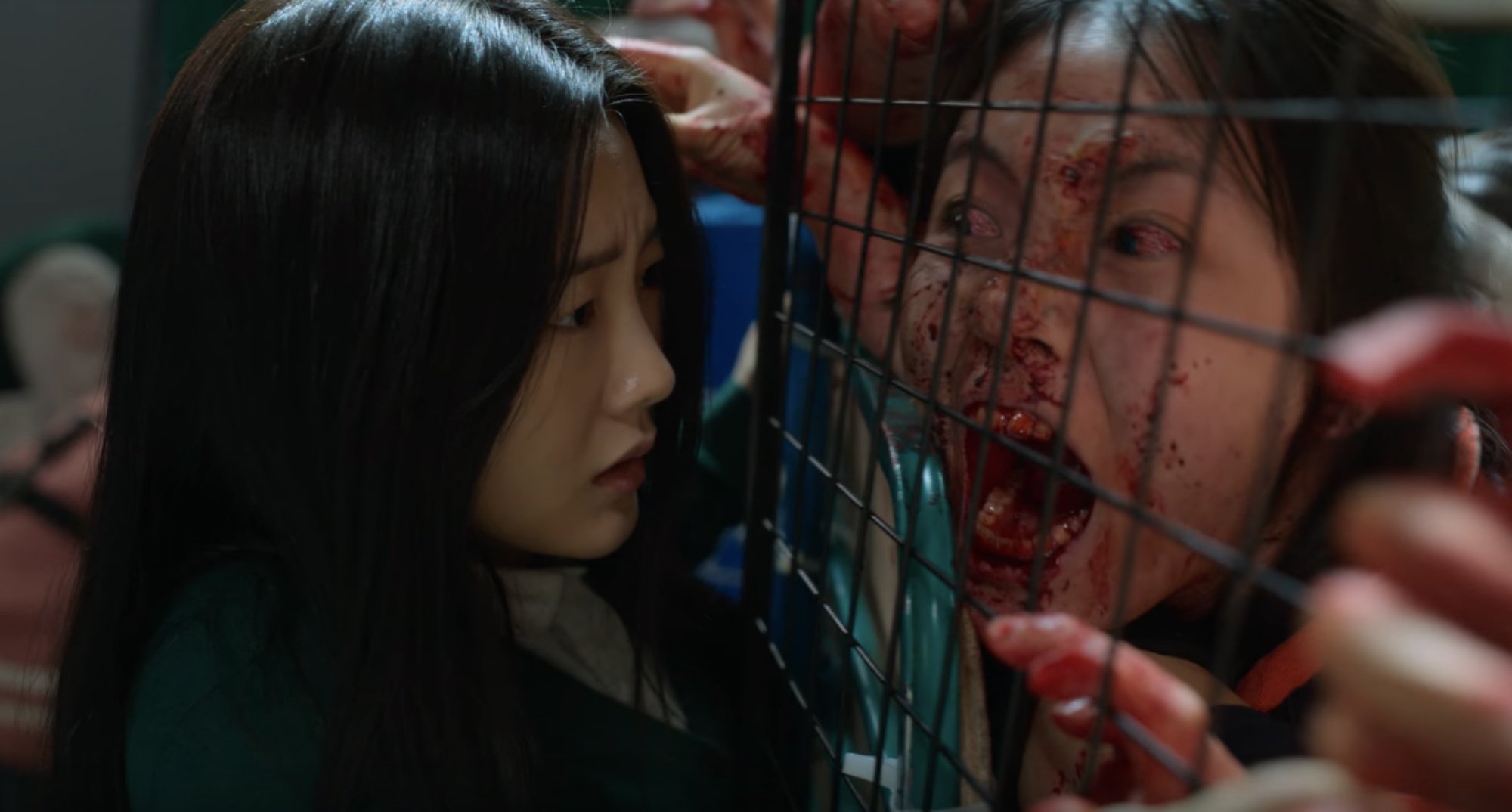 Nam-ra and zombies with Jonas virus in 'All of Us Are Dead' staring at each other.