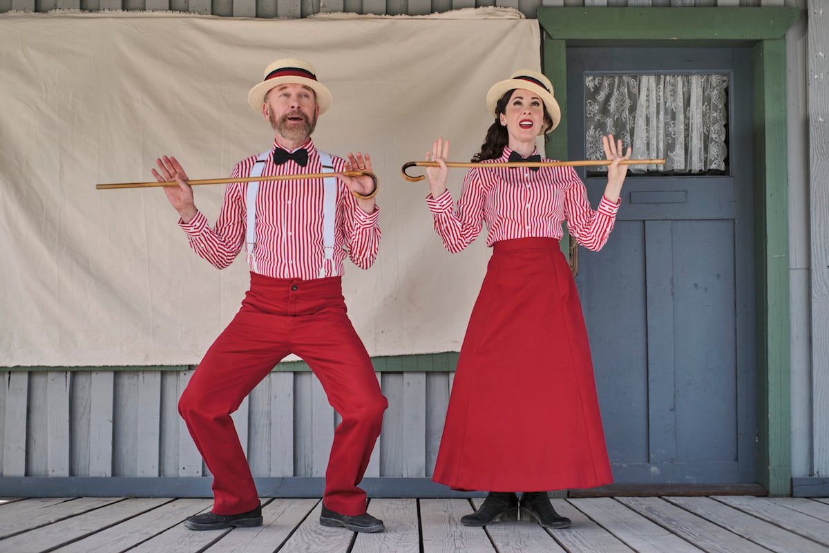 Ned and Florence, both wearing red striped shirts and red bottoms, performing in 'When Calls the Heart' Season 9